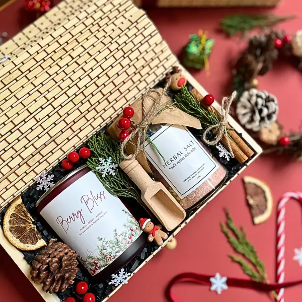 Christmas gift set with candle, herbal salt, pinecone, dried orange, and gingerbread man.