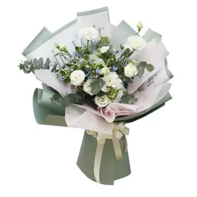 White roses, hydrangeas, and blue filler flowers with eucalyptus in a pale green and white bouquet.
