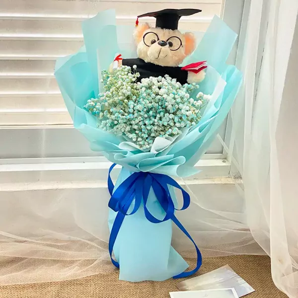 Graduation teddy bear bouquet with blue baby's breath flowers.