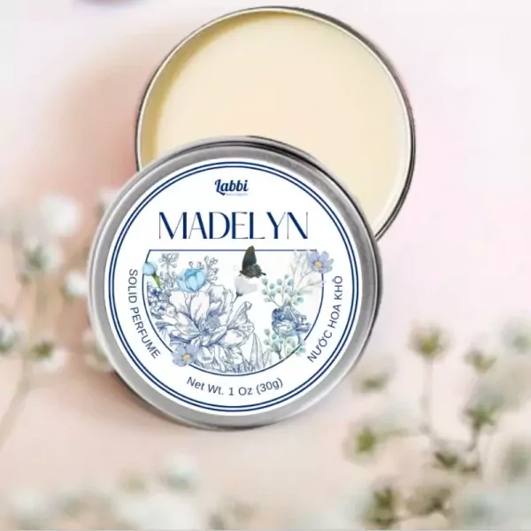 Tin of Madelyn solid perfume with floral and butterfly design.