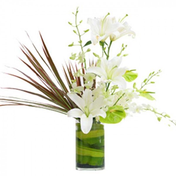 White lilies and green anthurium in a green striped vase.
