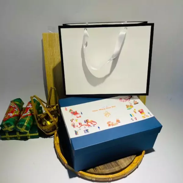 A gift box with candles, greeting cards, and decorative items.