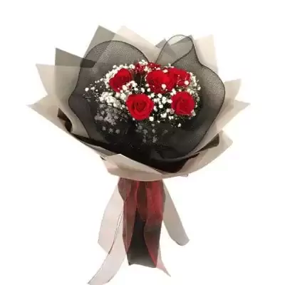 Bouquet of red roses with baby's breath and black and white wrapping.