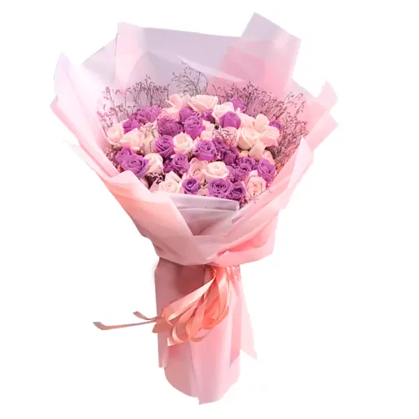 A bouquet of pink and purple roses wrapped in pink paper with a pink ribbon.