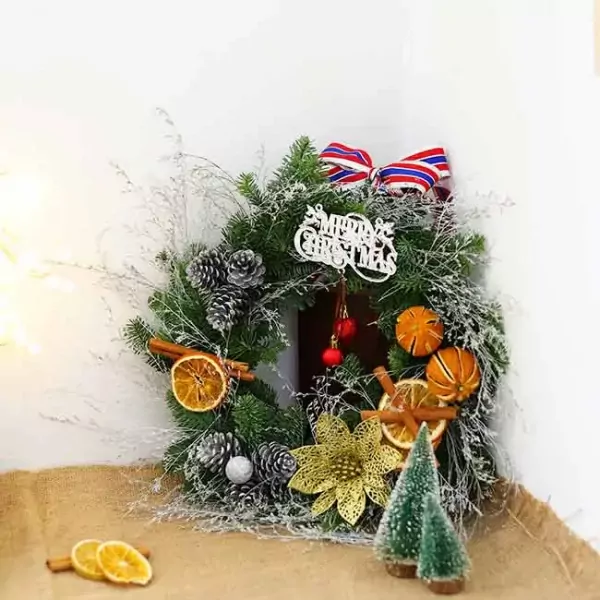Christmas wreath with pinecones, dried oranges, cinnamon, and gold flower.