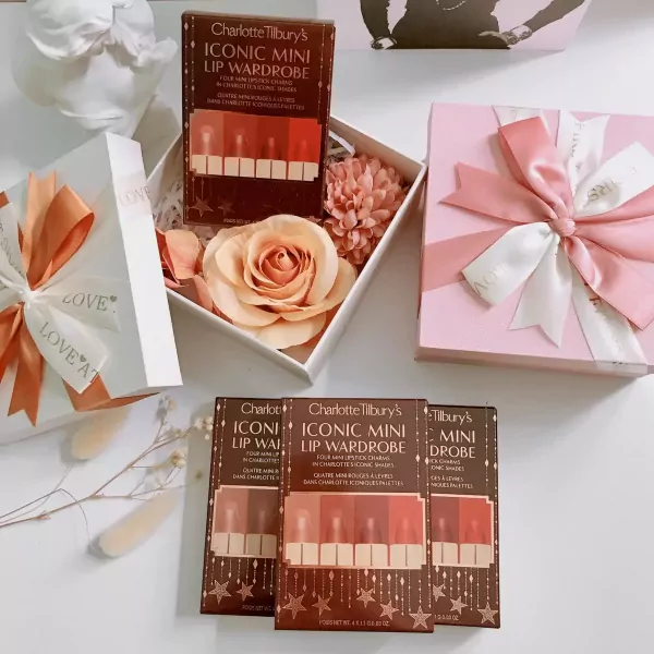 Charlotte Tilbury lipstick sets with roses, gift boxes, and ribbon.