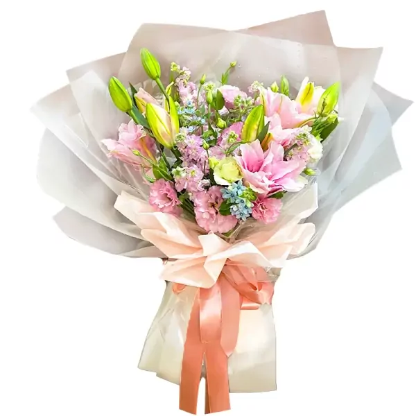 Pink lilies, lisianthus, and delphinium in a bouquet wrapped in sheer paper with a peach bow.
