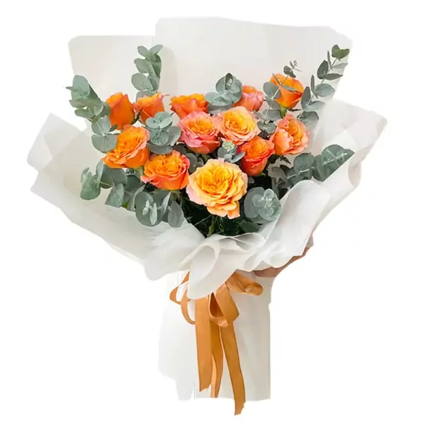 Bouquet of orange and pink roses with eucalyptus, wrapped in white paper and tied with an orange ribbon.