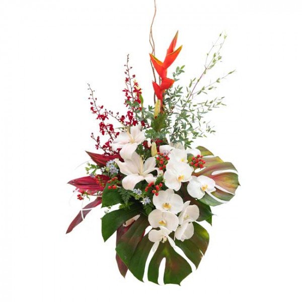 Orchid and lily flower arrangement with red heliconia and tropical leaves.