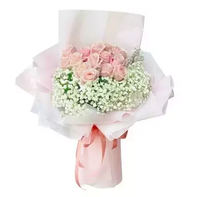 Pink roses and baby's breath bouquet wrapped in light pink paper, tied with a pink ribbon.