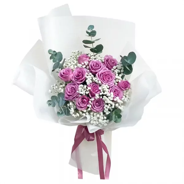 Bouquet of purple roses and baby's breath flowers wrapped in white paper.