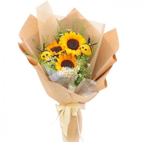 Sunflower bouquet with yellow ping pong mums and decorative bees, wrapped in brown paper.