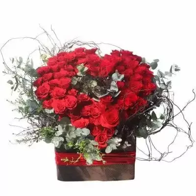 Box of 99 red roses with eucalyptus and decorative twigs in a square box.