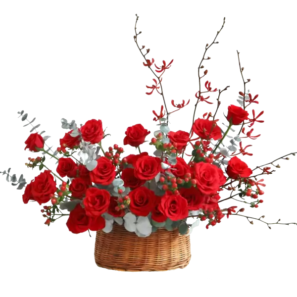 Basket of red roses with decorative branches and leaves.
