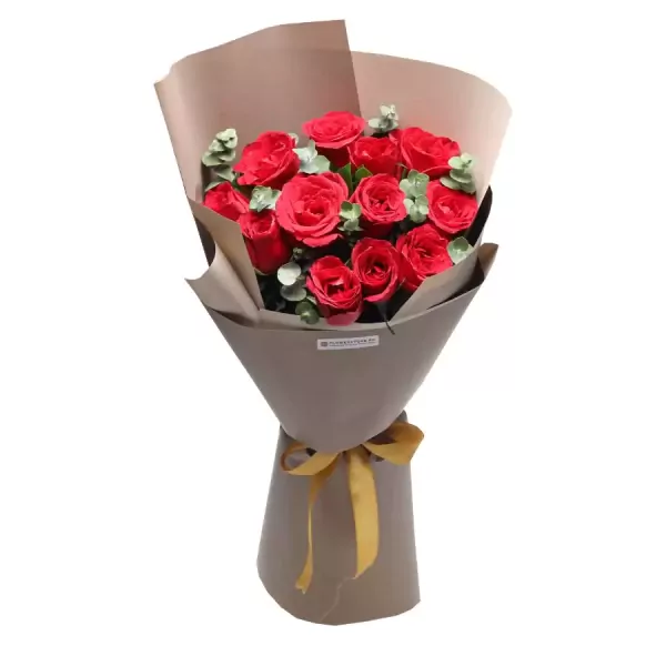 A bouquet of red roses with green leaves, wrapped in brown paper and tied with a gold ribbon.