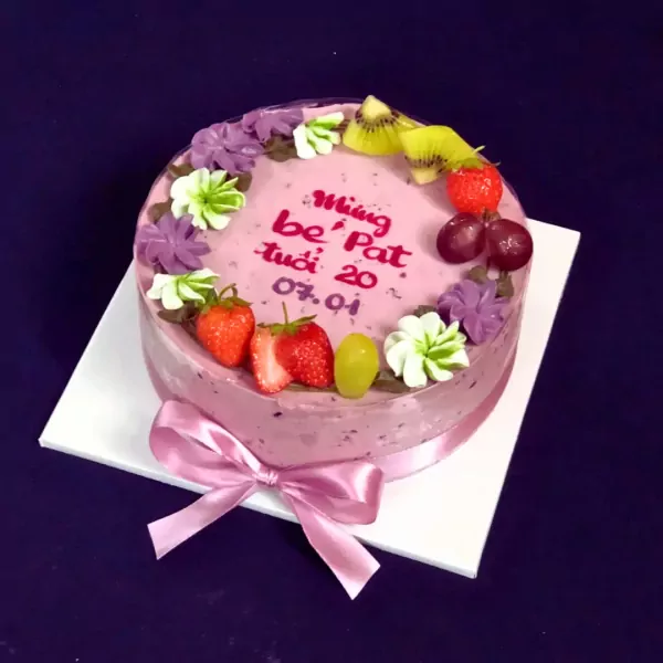 Pink mulberry yogurt mousse cake with "Mừng bé Pat tuổi 20 07.01" written in red, topped with strawberries and kiwi.