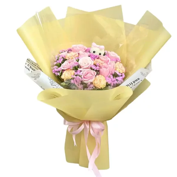 Bouquet of pink and peach roses with purple filler flowers, wrapped in yellow paper and tied with a pink ribbon.