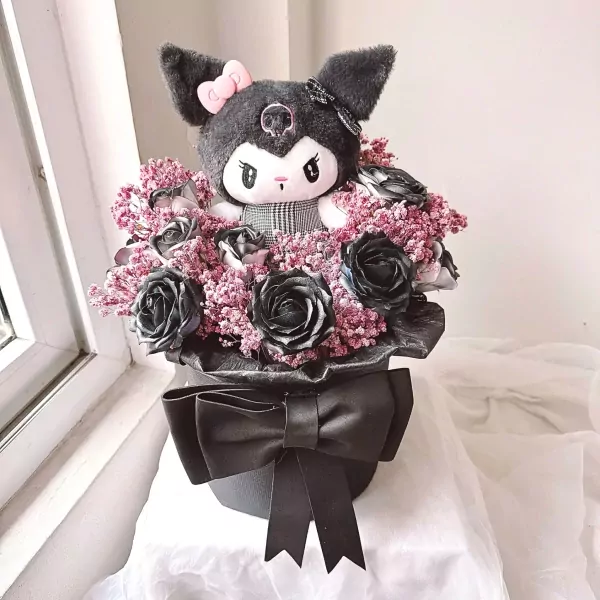 Kuromi plush in a bouquet of black roses and pink filler flowers, with a large black bow.