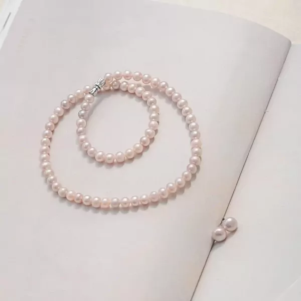 Pearlie pearl necklace and matching earrings on a white background.