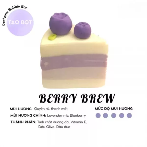 A slice of layered soap cake with blueberries on top, labeled "Berry Brew".