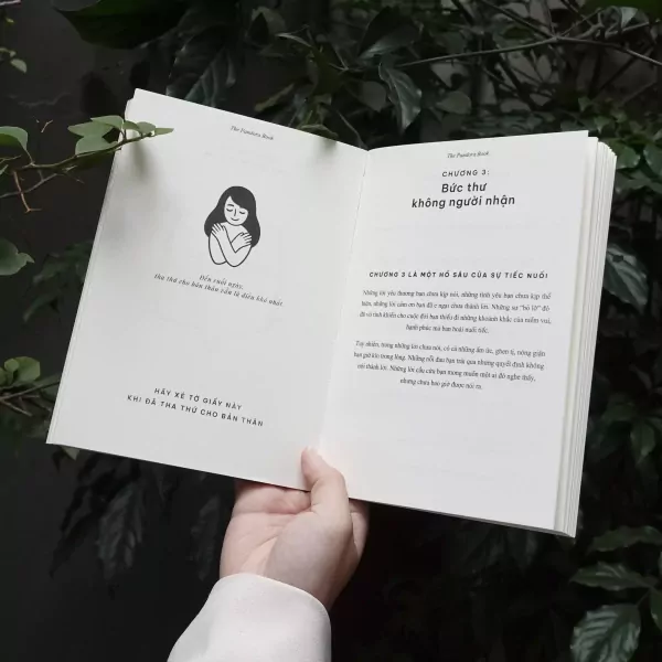 Open book with illustration of a person hugging themselves.