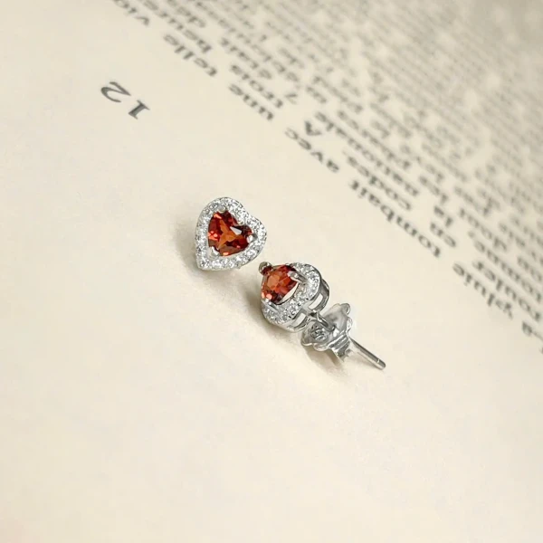 Crimson heart garnet and diamond halo stud earrings set in silver.