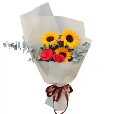 Bouquet of sunflowers and red roses with eucalyptus leaves, wrapped in pale paper with a brown ribbon.