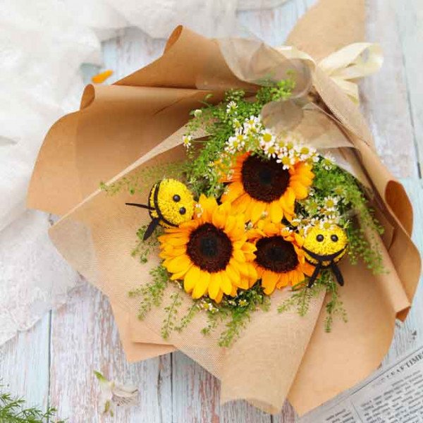 Sunflower bouquet with yellow ping pong daisies and bee ornaments.