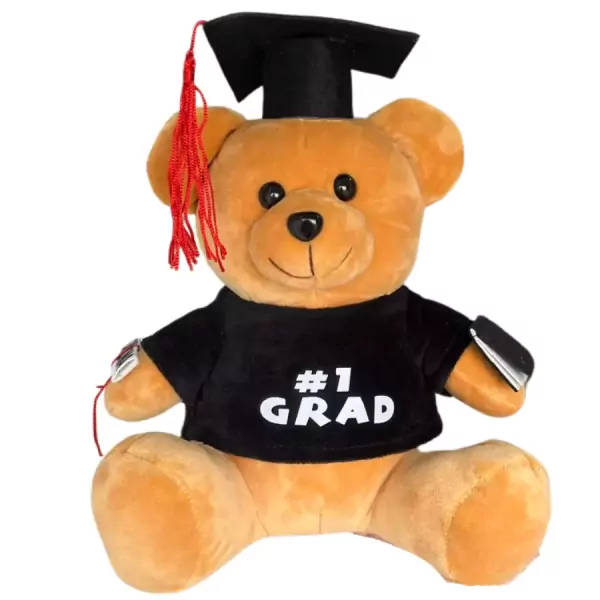 Brown teddy bear in graduation cap and gown, holding a "#1 GRAD" shirt.
