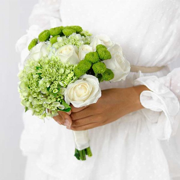 White and green wedding bouquet with roses, hydrangeas, and button mums.