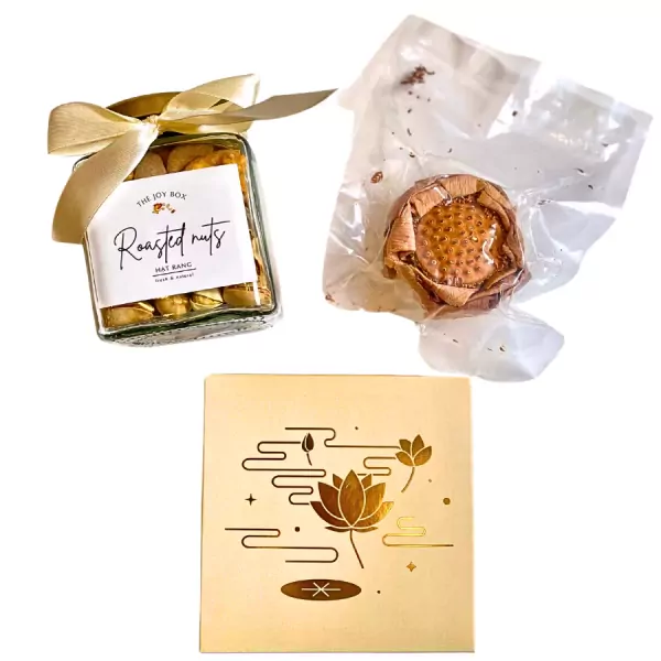 Gift set with jar of roasted nuts, vacuum-sealed dried lotus, and a golden box with lotus design.