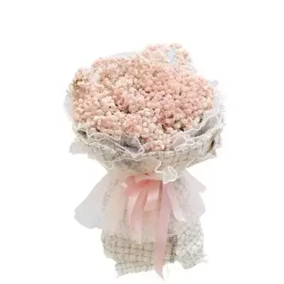 Pink baby's breath bouquet wrapped in textured fabric with a pink ribbon.