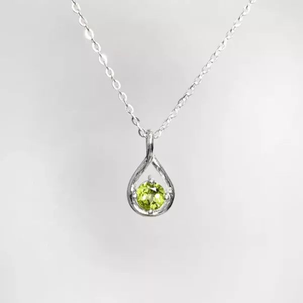 Sterling silver necklace with a teardrop pendant holding a green peridot gemstone.