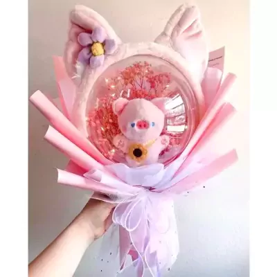 Pink pig balloon bouquet with cat ears and flower accent.