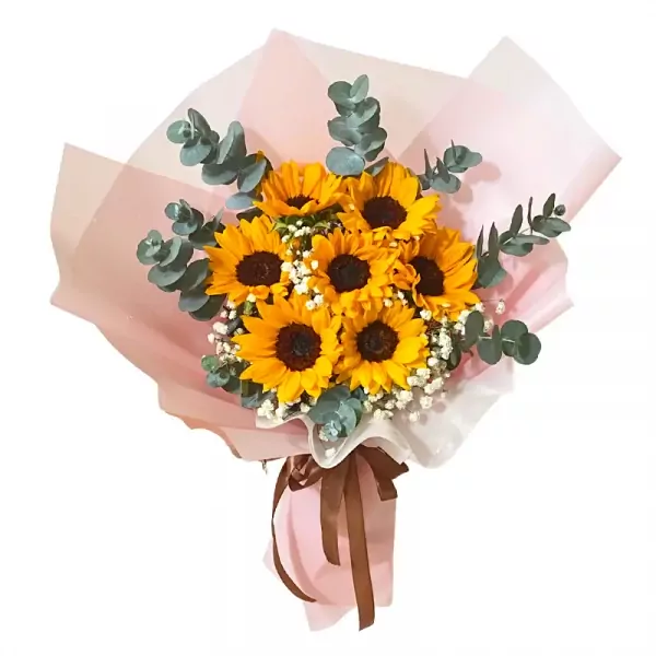 Bouquet of seven bright yellow sunflowers with baby's breath and eucalyptus, wrapped in pink paper and tied with a brown ribbon.