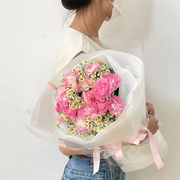 Pink carnation bouquet with baby's breath and bunny tail grass.