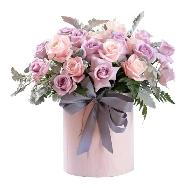 Round pink hatbox with pastel and lavender roses and a grey ribbon.