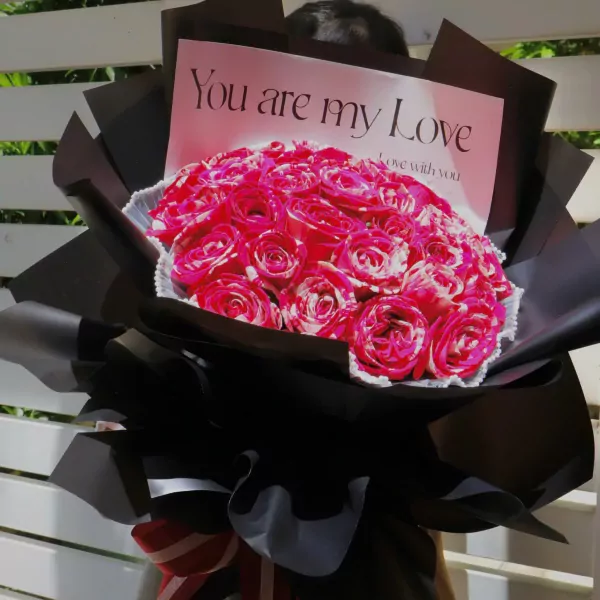 Bouquet of bicolor red and white roses with "You are my Love" card and red and white ribbon.