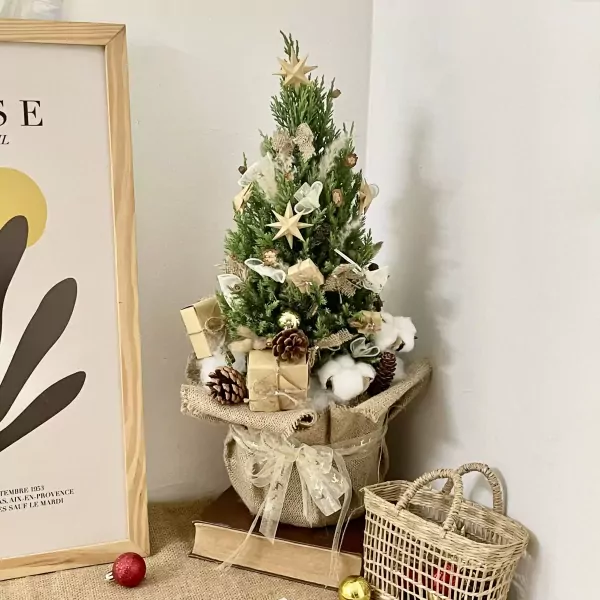 Decorated mini pine tree with pinecones, gifts, and stars.