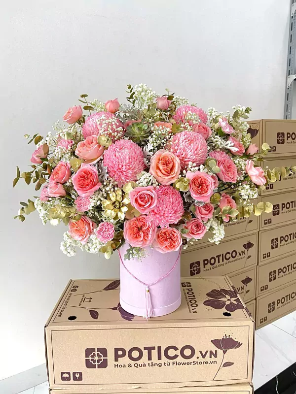 Pink peony and rose flower box with gold accents and tassel on pink hatbox.