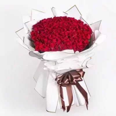A large bouquet of 200 red roses wrapped in white paper with a brown ribbon.