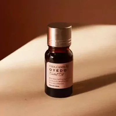 A small bottle of dark red essential oil with a silver cap and pink label that reads "OYEDO Essential Oil".