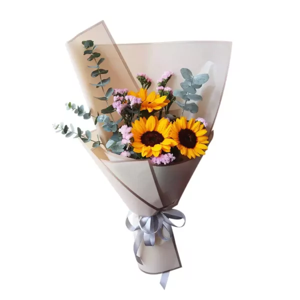 Bouquet of sunflowers and purple statice with eucalyptus leaves, wrapped in brown paper with a silver ribbon.