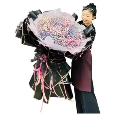 Woman holding a large bouquet of colorful baby's breath flowers.