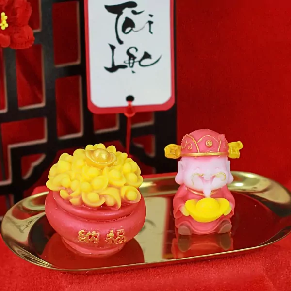 Golden fortune wax set with a potted flower and a god of wealth figurine.