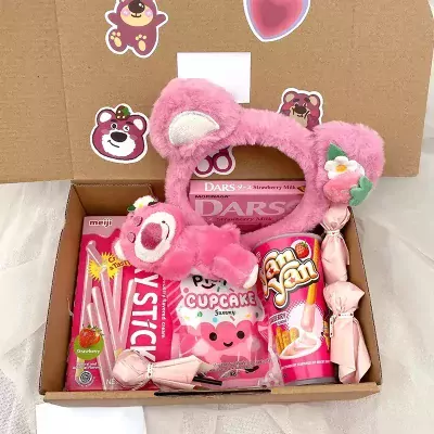 Pink gift box with candy, strawberry milk chocolate, and a teddy bear headband with ears.