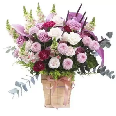 Pink and purple flowers in a wooden box with a pink ribbon.