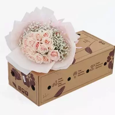 Bouquet of pink roses and baby's breath in a cardboard box.