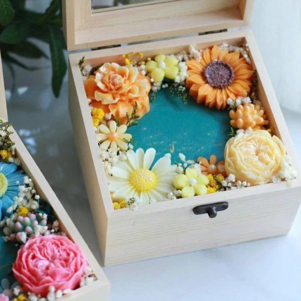 Wooden gift box filled with colorful soap flowers and dried baby's breath.