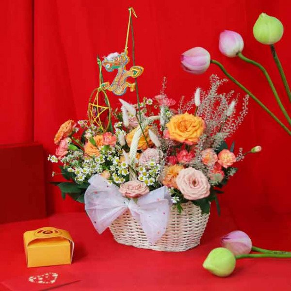 Flower basket with roses, carnations, daisies, lotus buds and a dragon lantern ornament.